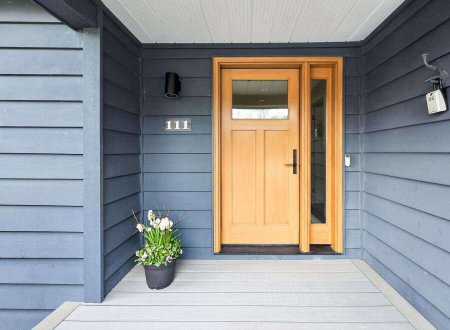 This stunning property boasts a welcoming entrance with a beautiful wooden door and sidelight, creating an inviting first impression.