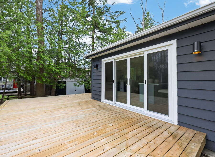 Enjoy outdoor living at its finest with this stunning property featuring a spacious wooden deck.
