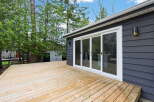 Enjoy outdoor living at its finest with this stunning property featuring a spacious wooden deck.