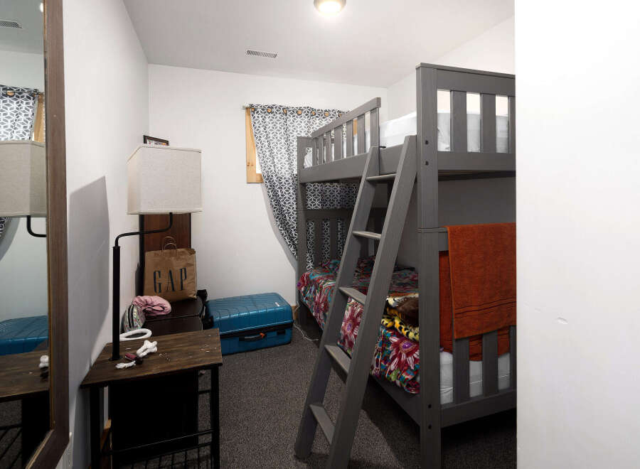 This cozy bedroom features a stylish bunk bed, perfect for accommodating guests or family members.