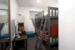 This cozy bedroom features a stylish bunk bed, perfect for accommodating guests or family members.
