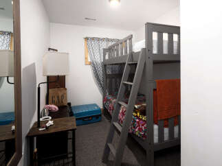 This cozy bedroom features a stylish bunk bed, perfect for accommodating guests or family members.