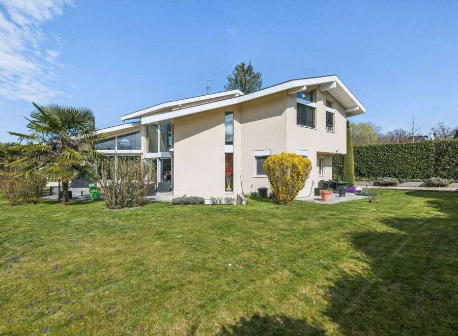 This stunning property boasts a modern architectural design with expansive windows that flood the interior with natural light.