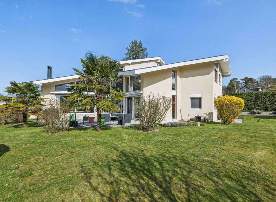 This stunning modern home boasts a sleek design with expansive windows, offering abundant natural light and scenic views.