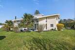 This stunning modern home boasts a sleek design with expansive windows, offering abundant natural light and scenic views.