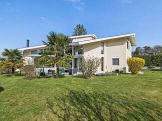 This stunning modern home boasts a sleek design with expansive windows, offering abundant natural light and scenic views.
