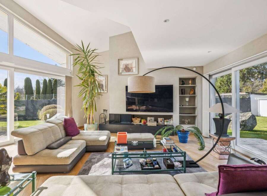 Experience luxury living in this stunning property, featuring a spacious living room with abundant natural light.