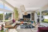 Experience luxury living in this stunning property, featuring a spacious living room with abundant natural light.