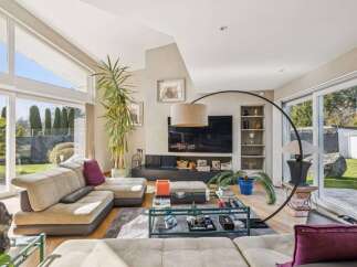 Experience luxury living in this stunning property, featuring a spacious living room with abundant natural light.