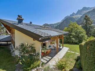 Experience serene mountain living in this charming chalet, featuring a spacious covered patio perfect for al fresco dining with breathtaking alpine views.