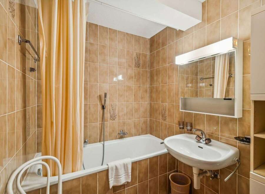 This charming bathroom features a classic design with warm, inviting tones.