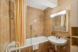 This charming bathroom features a classic design with warm, inviting tones.