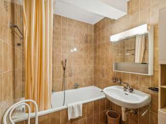 This charming bathroom features a classic design with warm, inviting tones.