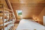 This cozy bedroom features a stunning wooden interior, creating a warm and inviting atmosphere.