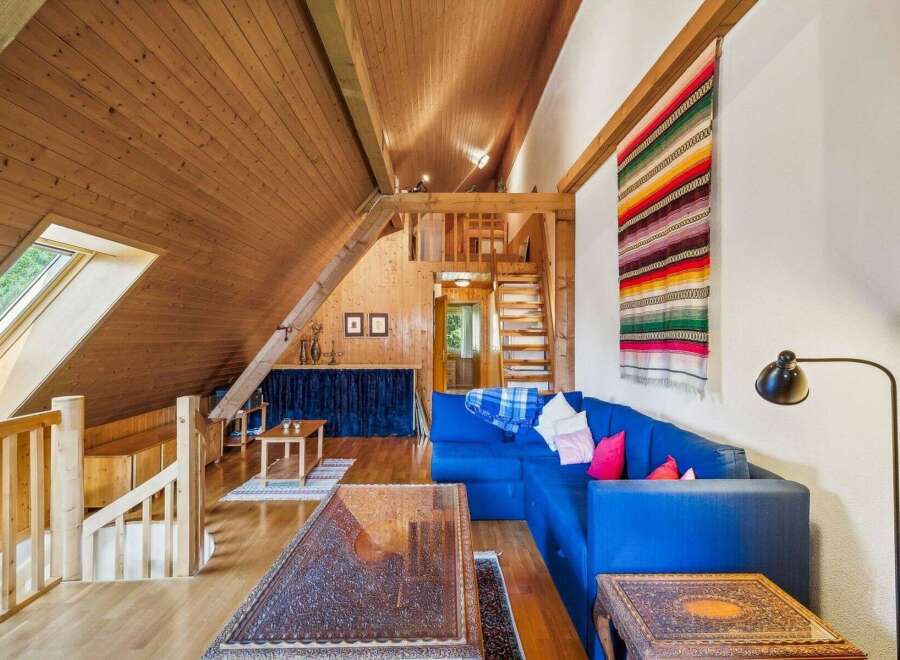 This stunning property boasts a unique architectural design with a cozy, inviting atmosphere.
