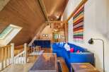 This stunning property boasts a unique architectural design with a cozy, inviting atmosphere.