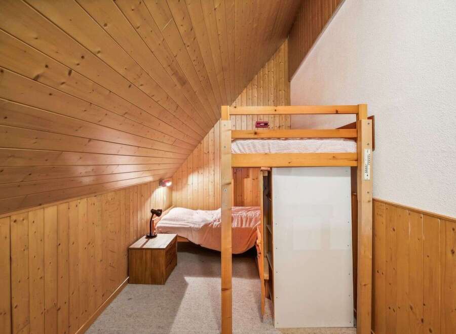 Discover the charm of this cozy bedroom featuring a unique loft bed design.