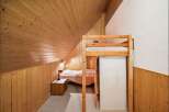 Discover the charm of this cozy bedroom featuring a unique loft bed design.