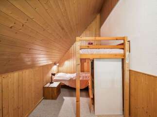 Discover the charm of this cozy bedroom featuring a unique loft bed design.