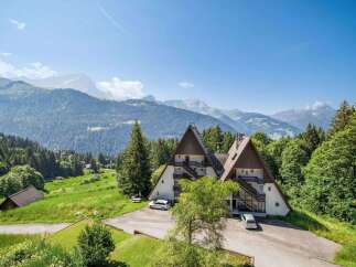Nestled in a picturesque mountain setting, this stunning property offers a unique architectural design.