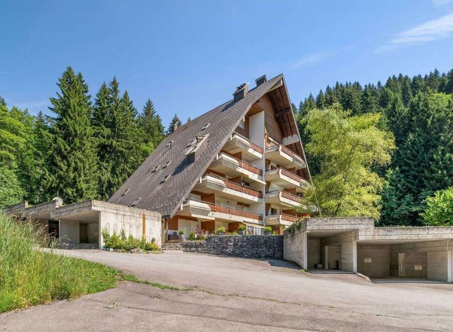 Discover this unique A-frame property nestled in a serene, wooded setting.
