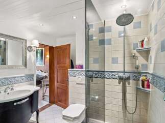 Step into this charming bathroom, featuring a blend of classic and modern elements.