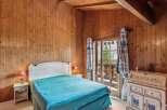 Step into a cozy bedroom retreat with stunning wooden paneling and a touch of rustic charm.