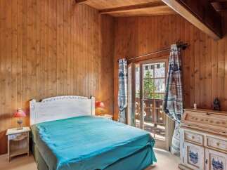 Step into a cozy bedroom retreat with stunning wooden paneling and a touch of rustic charm.