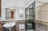 Step into luxury with this stunning bathroom! Featuring a sleek glass shower, elegant sink, and stylish storage solutions, this space is designed for both comfort and sophistication.