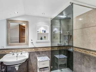 Step into luxury with this stunning bathroom! Featuring a sleek glass shower, elegant sink, and stylish storage solutions, this space is designed for both comfort and sophistication.