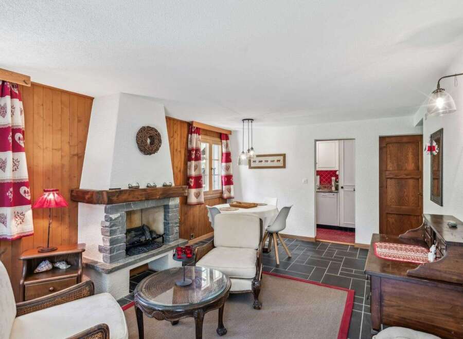 This charming property boasts a cozy living room with a rustic fireplace, perfect for those chilly evenings.