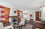 This charming property boasts a cozy living room with a rustic fireplace, perfect for those chilly evenings.