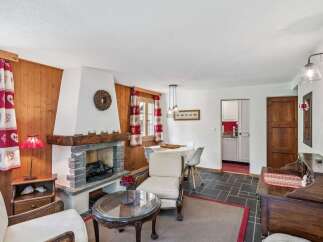 This charming property boasts a cozy living room with a rustic fireplace, perfect for those chilly evenings.
