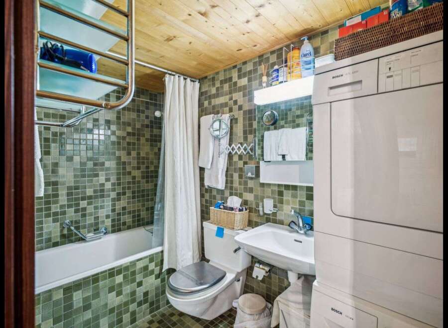 Step into this charming bathroom, featuring a unique mosaic tile design that adds character and style.