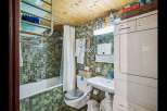 Step into this charming bathroom, featuring a unique mosaic tile design that adds character and style.