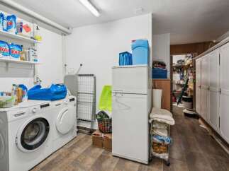 This laundry room offers a practical and organized space for all your washing needs.