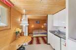 Discover the charm of this cozy cabin, featuring warm wooden interiors and a functional layout.