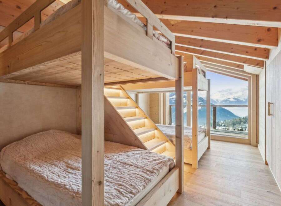 Experience the ultimate in alpine luxury with this stunning bunk bed setup.