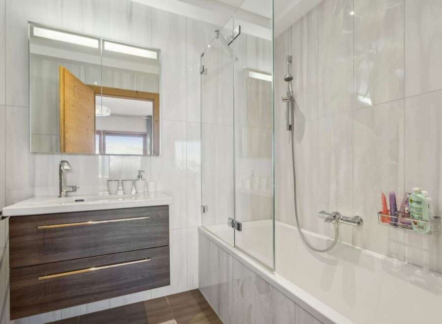 This modern bathroom features a sleek design with a combination of functionality and style.