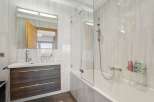 This modern bathroom features a sleek design with a combination of functionality and style.