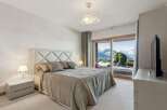 Experience luxury living in this stunning bedroom with breathtaking mountain views.