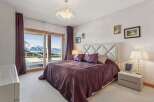 Experience luxury living in this stunning bedroom with breathtaking mountain views.