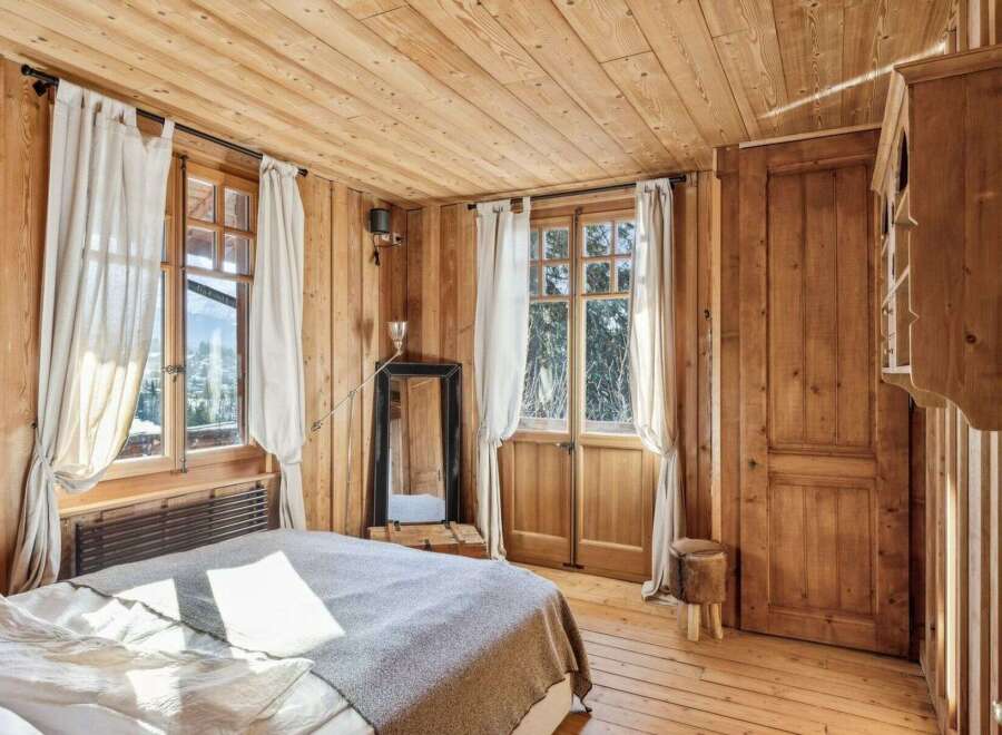 Step into a cozy bedroom retreat with stunning wooden accents throughout.