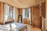 Step into a cozy bedroom retreat with stunning wooden accents throughout.