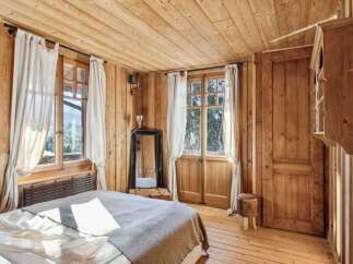 Step into a cozy bedroom retreat with stunning wooden accents throughout.