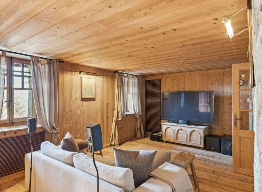 This cozy living room features a warm wooden interior, creating a rustic and inviting atmosphere.