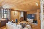 This cozy living room features a warm wooden interior, creating a rustic and inviting atmosphere.