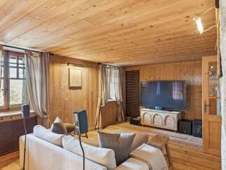 This cozy living room features a warm wooden interior, creating a rustic and inviting atmosphere.