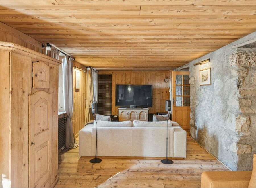 Step into rustic elegance with this stunning property, featuring a warm wooden interior and a cozy ambiance.