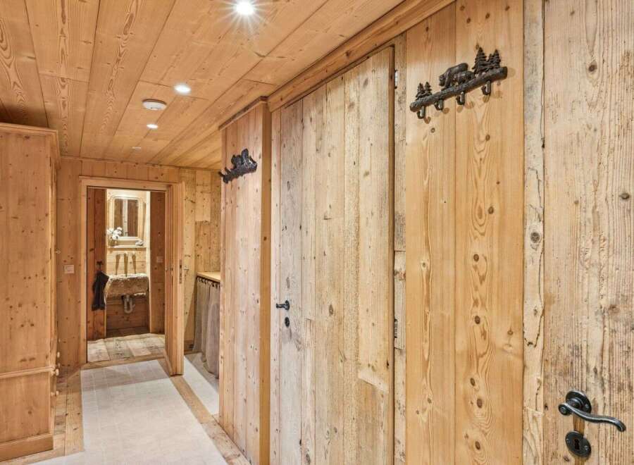 Step into rustic elegance with this stunning hallway, showcasing exquisite wooden paneling and a warm, inviting ambiance.